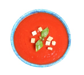 Bowl with fresh homemade tomato soup on white background, top view