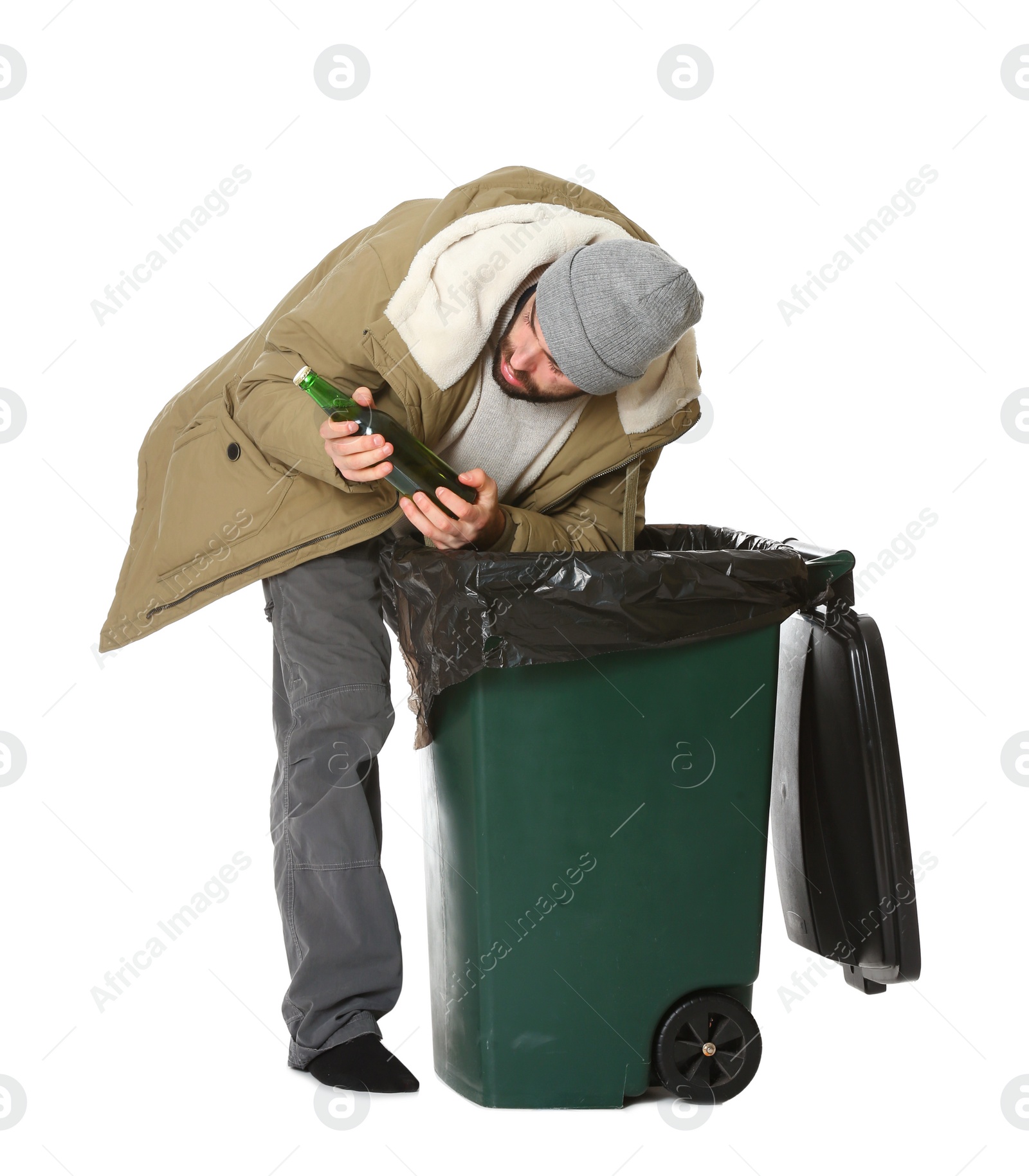 Photo of Poor homeless man digging in trash bin isolated on white