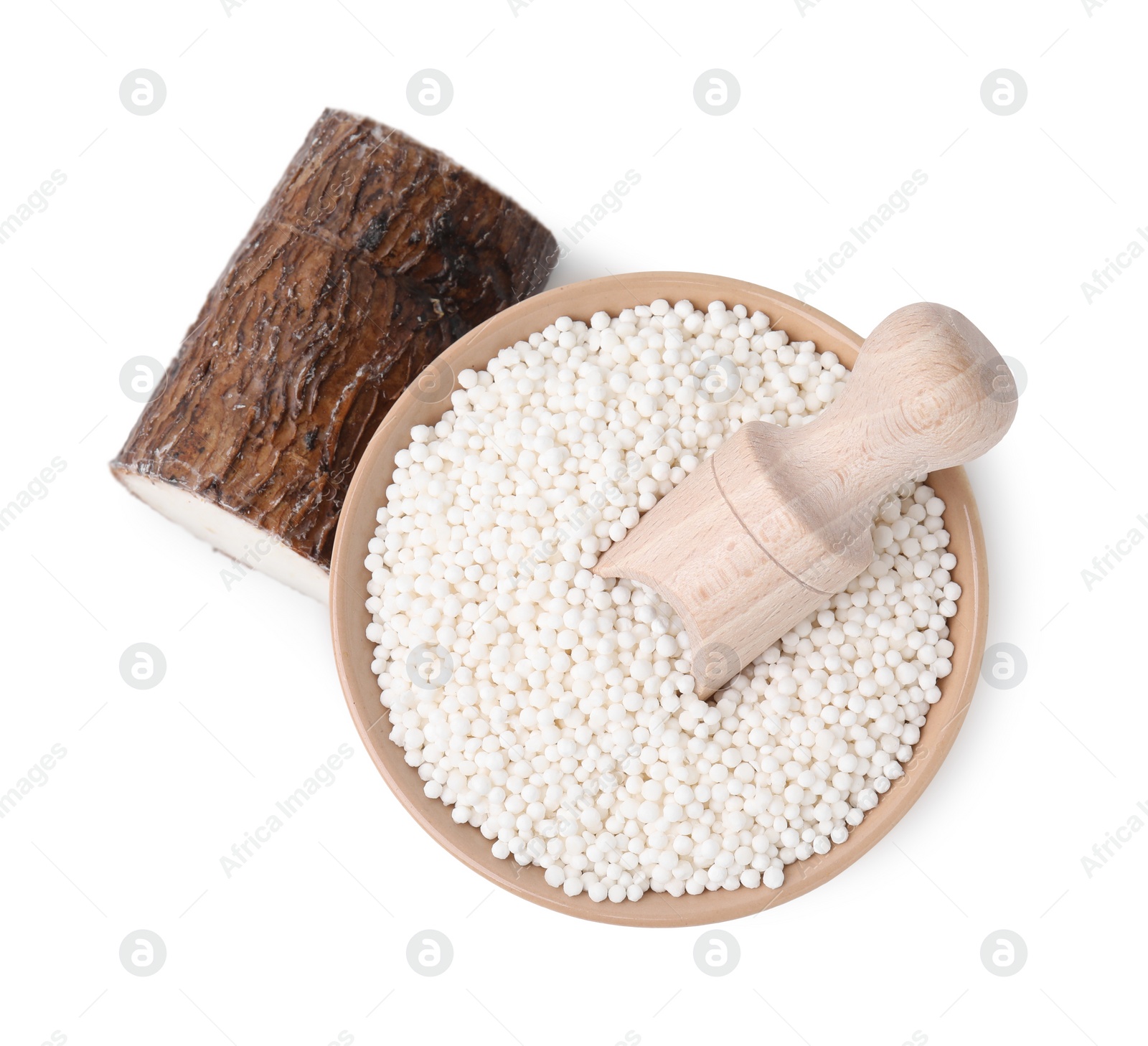 Photo of Tapioca pearls in bowl, scoop and cassava root isolated on white, top view