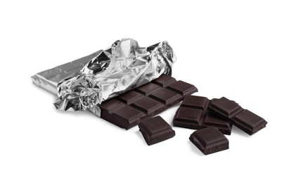 Pieces of delicious dark chocolate bar on white background