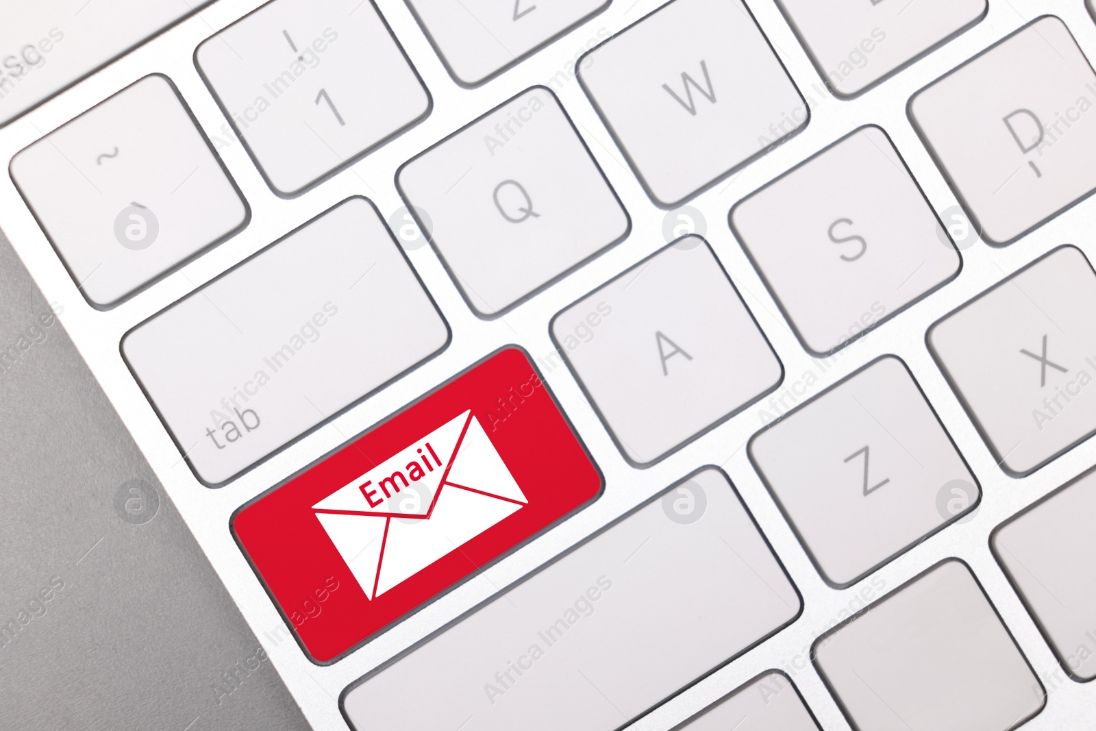 Image of Red button with word Email and illustration of envelope on keyboard, top view