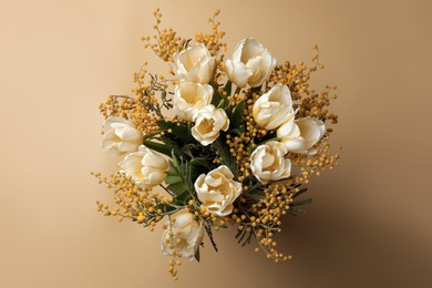 Photo of Bouquet with beautiful tulips and mimosa flowers on yellow background, top view