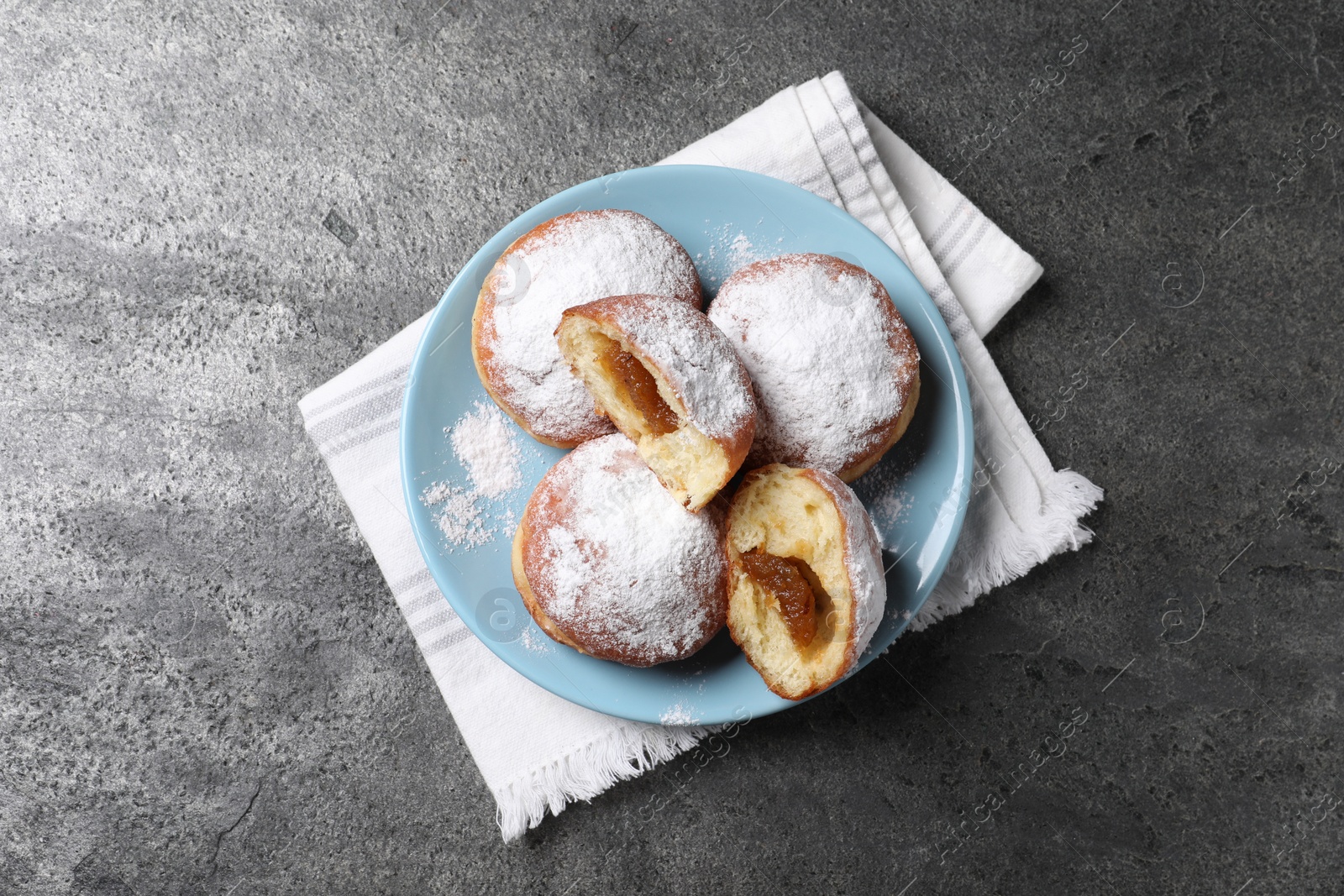 Photo of Delicious sweet buns with jam on gray table, top view