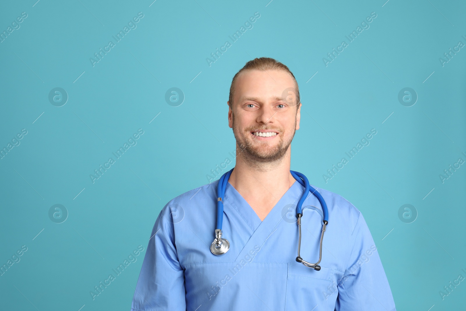 Photo of Portrait of medical assistant with stethoscope on color background. Space for text