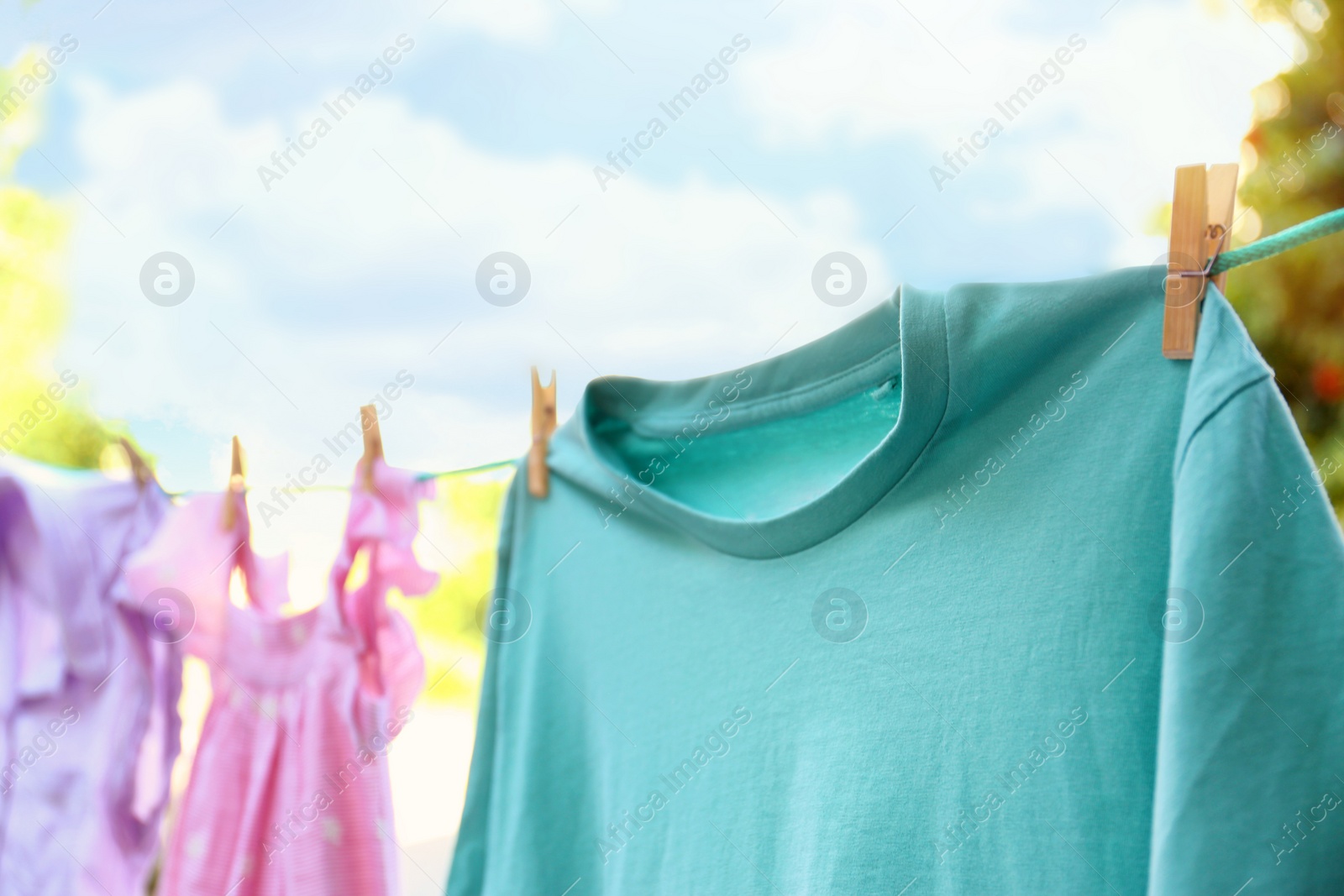 Photo of Clothes on laundry line outdoors on sunny day