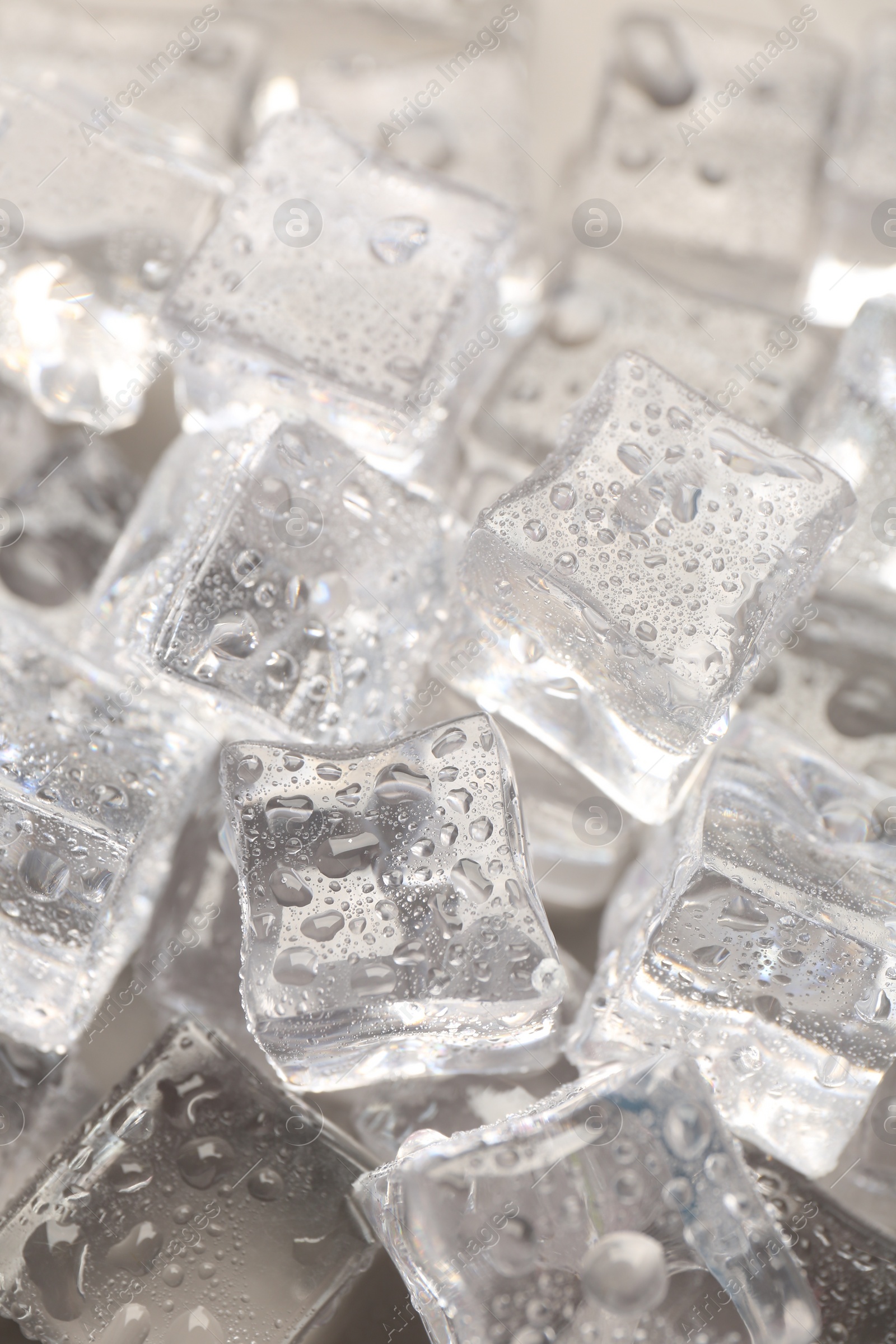 Photo of Melting ice cubes with water drops as background, closeup