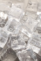 Melting ice cubes with water drops as background, closeup