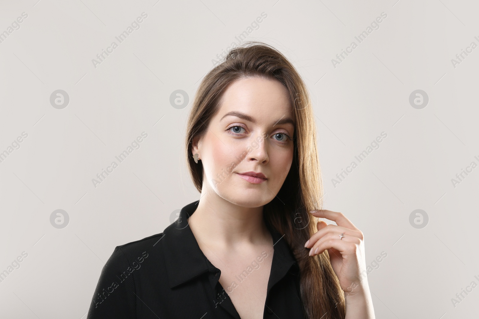 Photo of Portrait of beautiful young woman on beige background