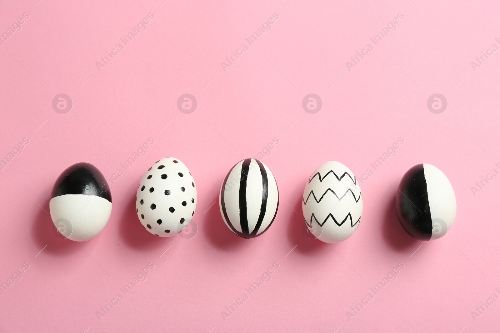 Photo of Painted Easter eggs on color background, top view