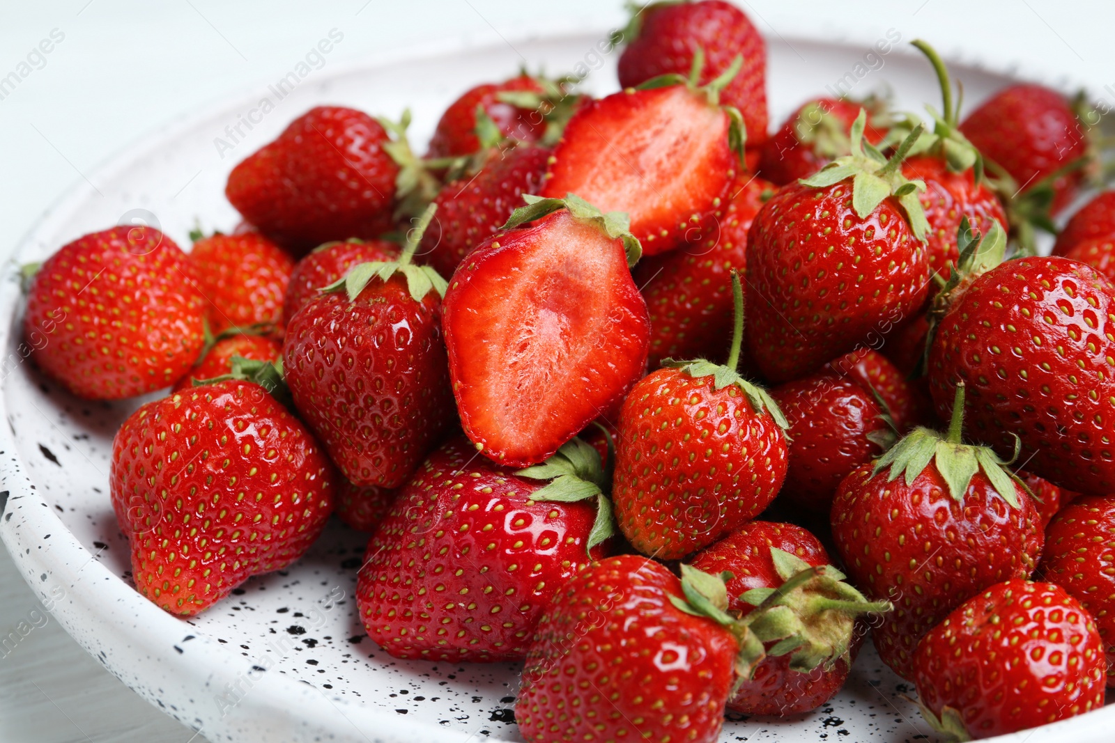 Photo of Delicious ripe strawberries on white plate, closeup