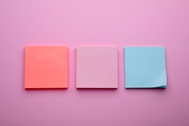 Photo of Paper notes on pale pink background, flat lay