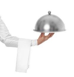 Waiter holding metal tray with lid on white background, closeup