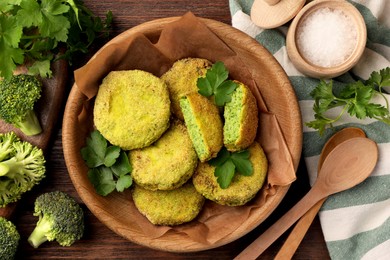 Photo of Tasty vegan cutlets and ingredients on wooden table, flat lay