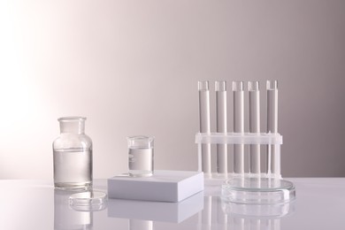 Laboratory analysis. Different glassware on table against light background