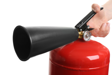 Woman using fire extinguisher on white background, closeup