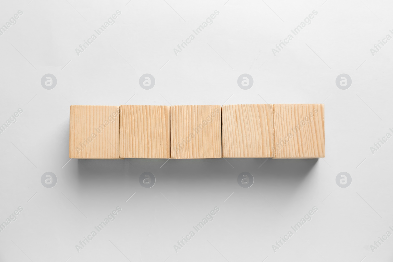 Photo of Blank wooden cubes on light background, flat lay. Space for text