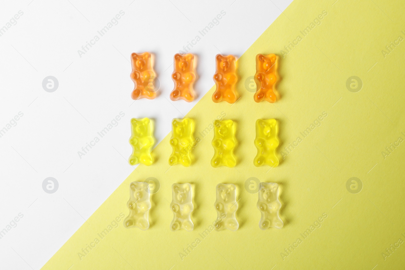 Photo of Delicious jelly bears on color background, top view