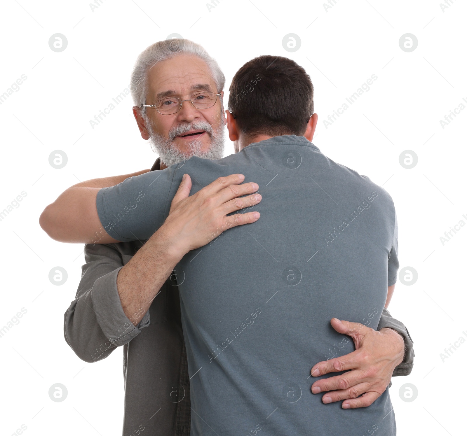 Photo of Happy dad and his son hugging on white background