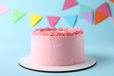 Photo of Cute bento cake with tasty cream on light blue background