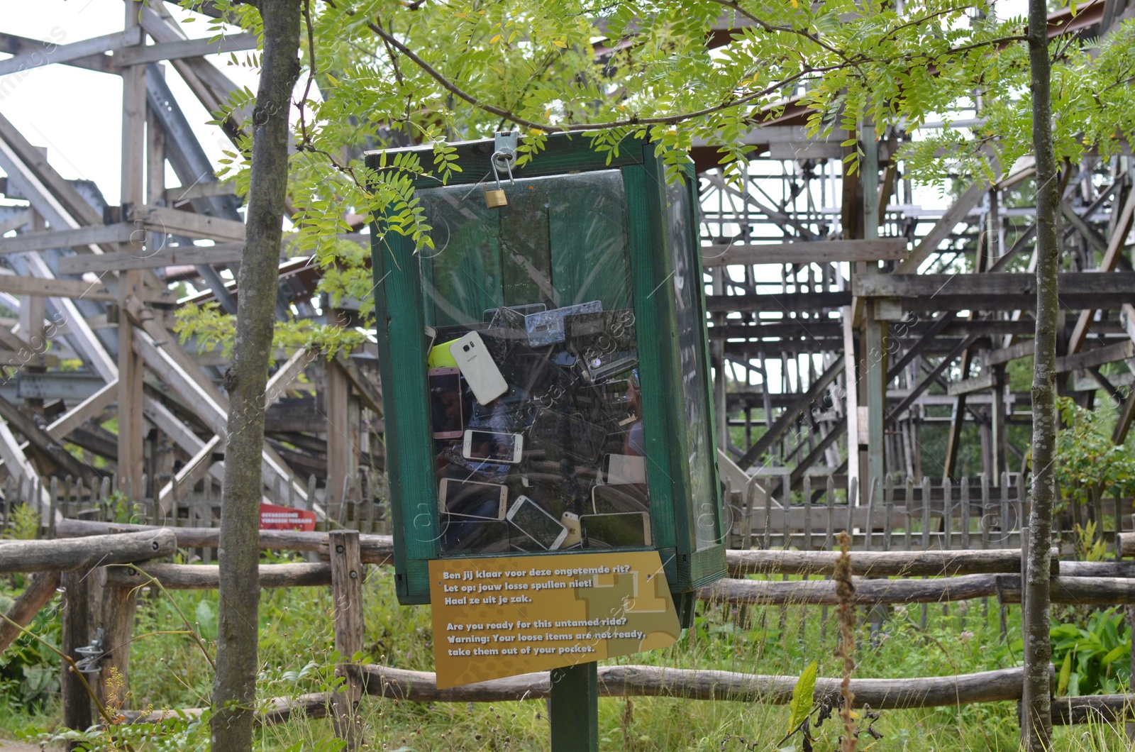 Photo of Amsterdam, The Netherlands - August 8, 2022: Outdoor transparent safe with many broken smartphones in Walibi Holland amusement park