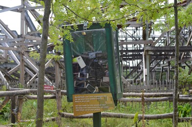 Photo of Amsterdam, The Netherlands - August 8, 2022: Outdoor transparent safe with many broken smartphones in Walibi Holland amusement park