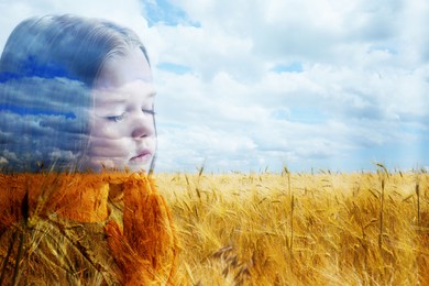 Image of Pray for Ukraine. Double exposure of little girl and wheat field under cloudy sky