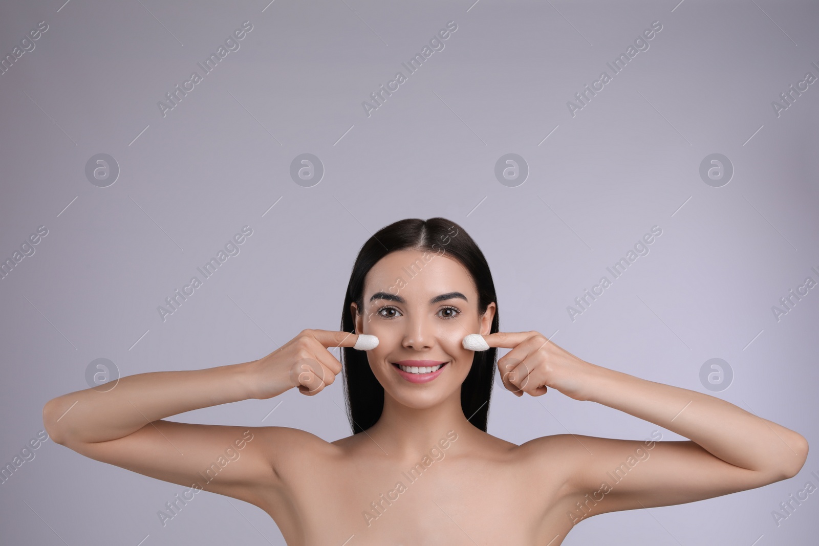 Photo of Woman using silkworm cocoons in skin care routine on light grey background. Space for text