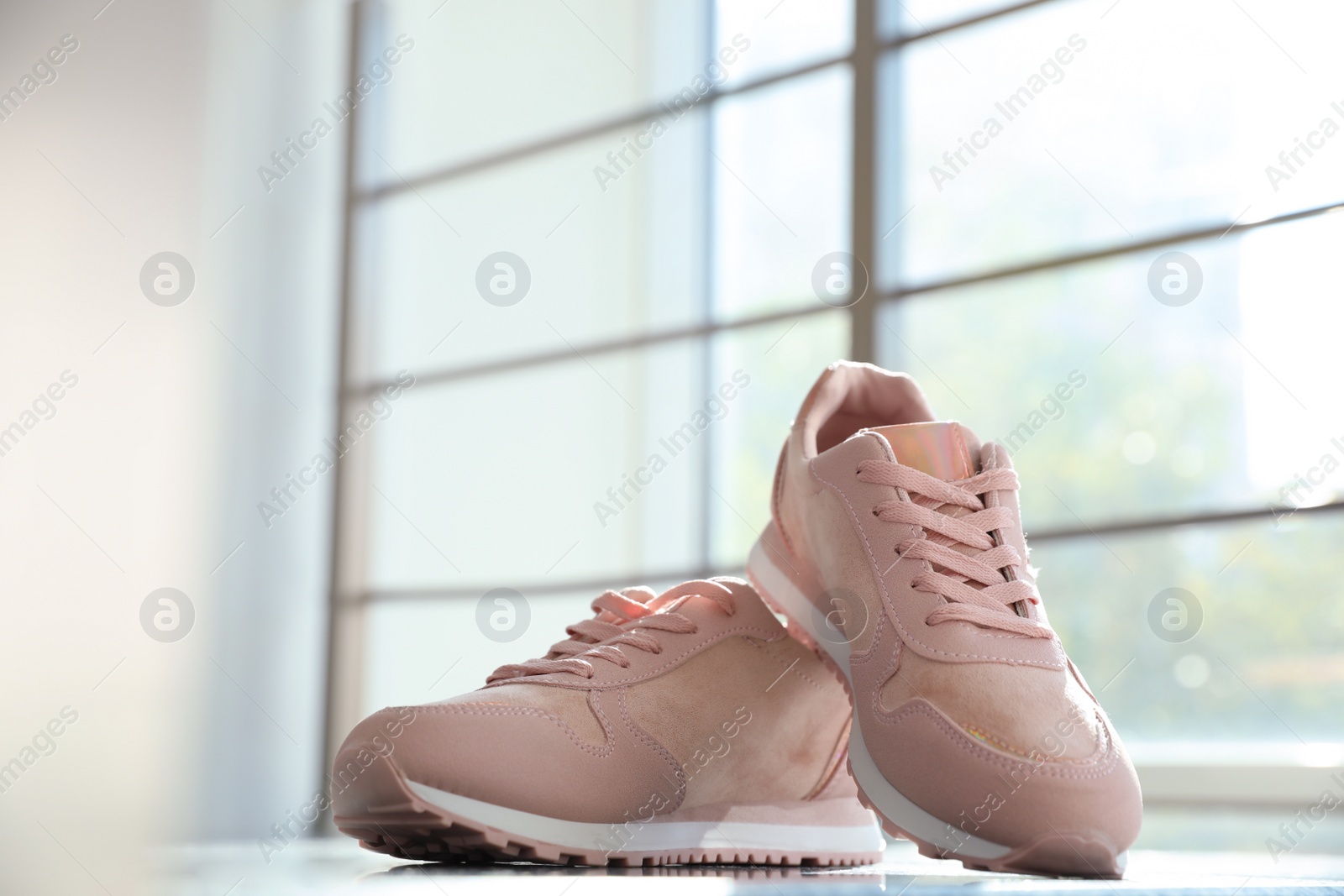 Photo of Pair of stylish women's sneakers on staircase indoors