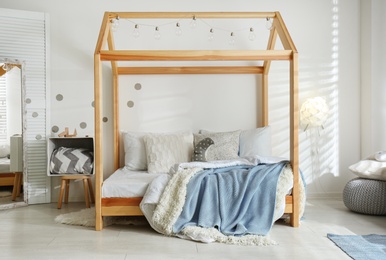 Photo of Cozy child room interior with comfortable bed