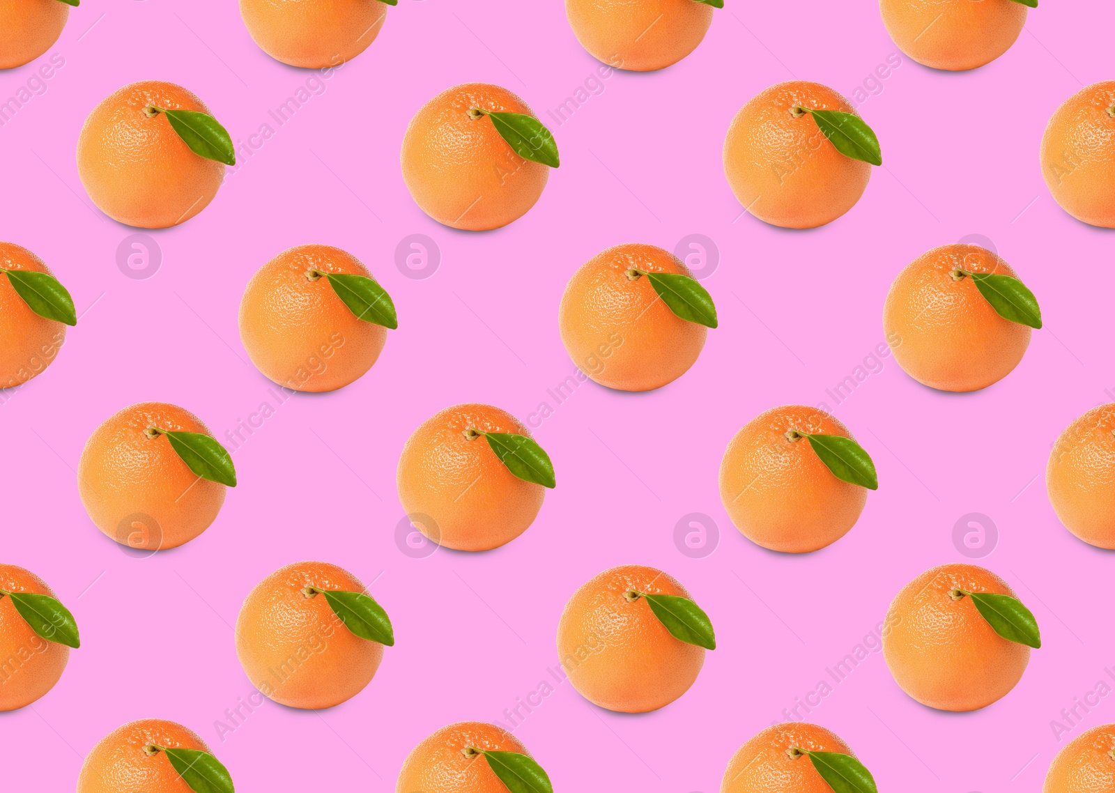 Image of Many fresh ripe grapefruits on pink background. Seamless pattern design