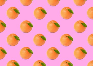 Image of Many fresh ripe grapefruits on pink background. Seamless pattern design