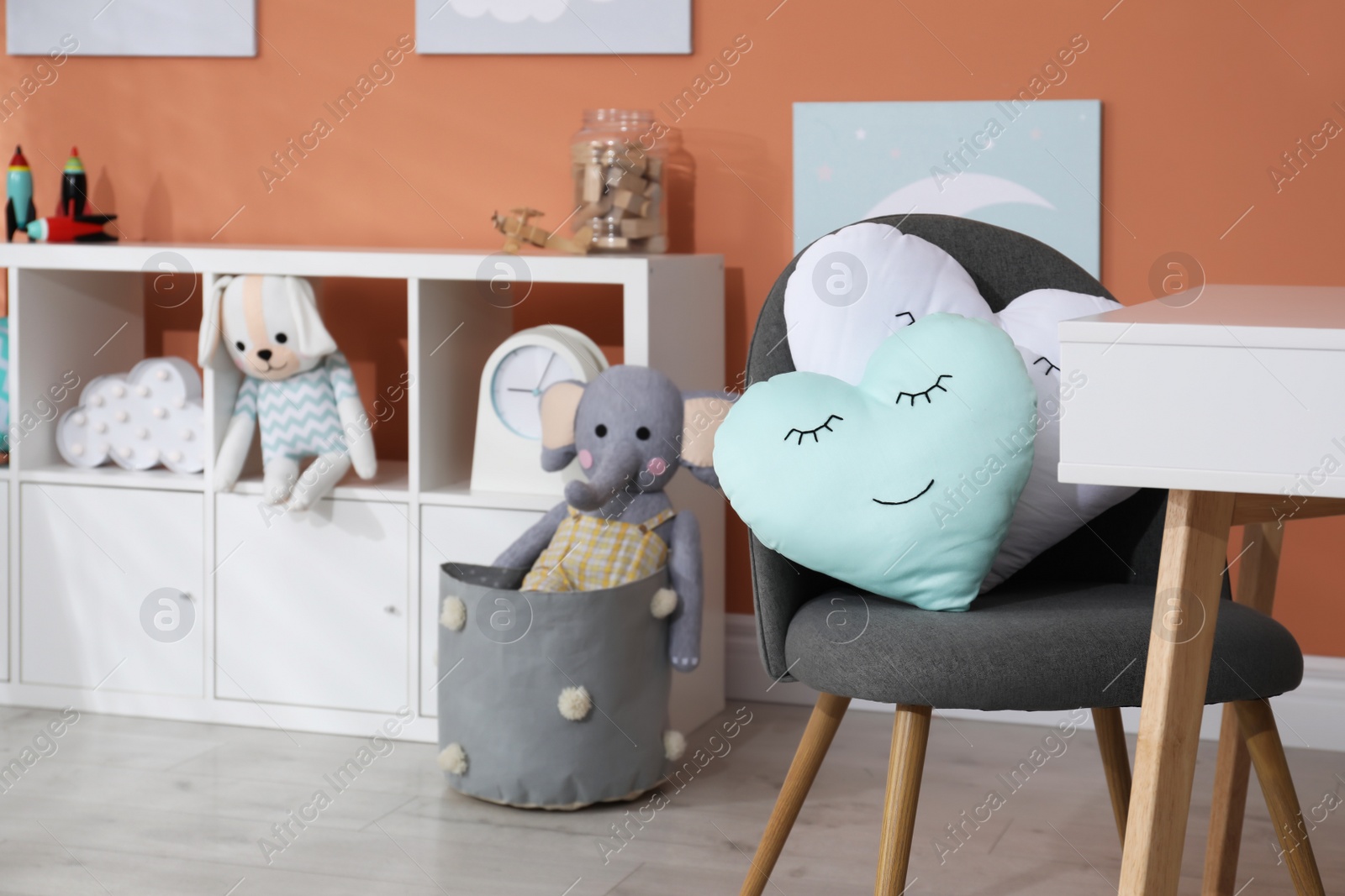 Photo of Cute child's room interior with toys and modern furniture