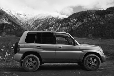 Modern car in beautiful mountains. Black and white effect