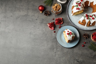 Flat lay composition with traditional homemade Christmas cake on grey table, space for text