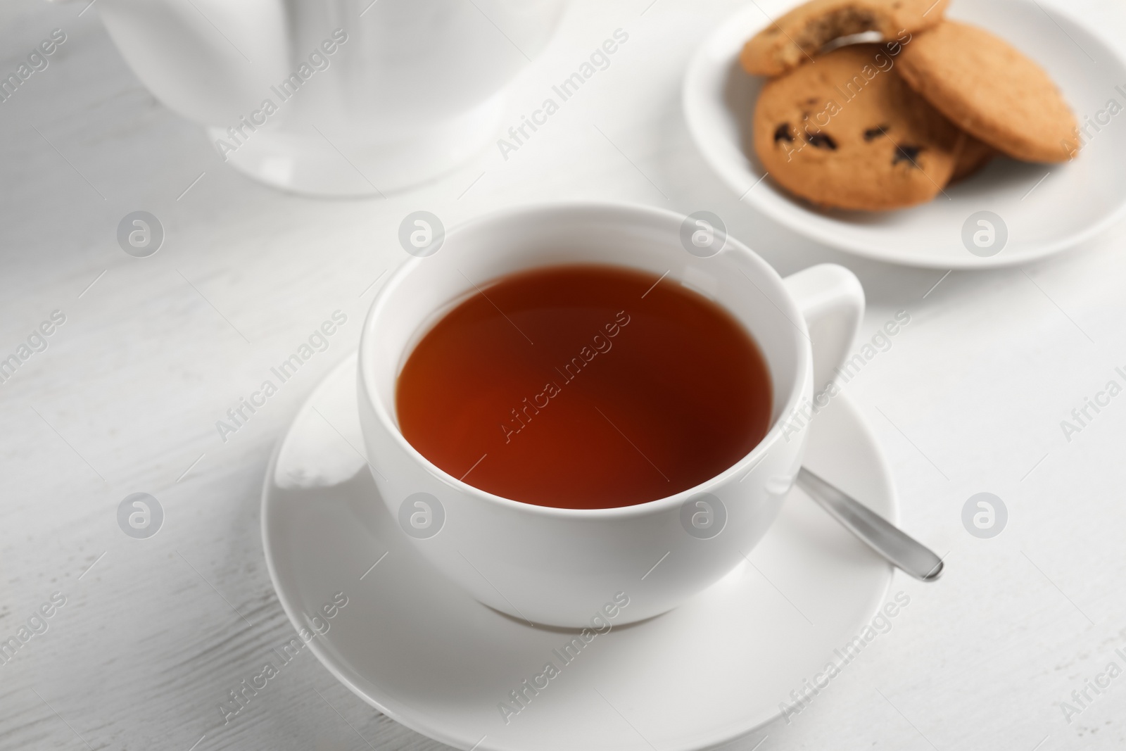 Photo of Cup of delicious tea with saucer on table