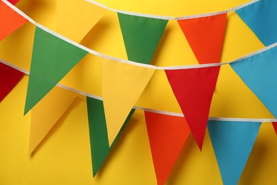 Photo of Buntings with colorful triangular flags on yellow background