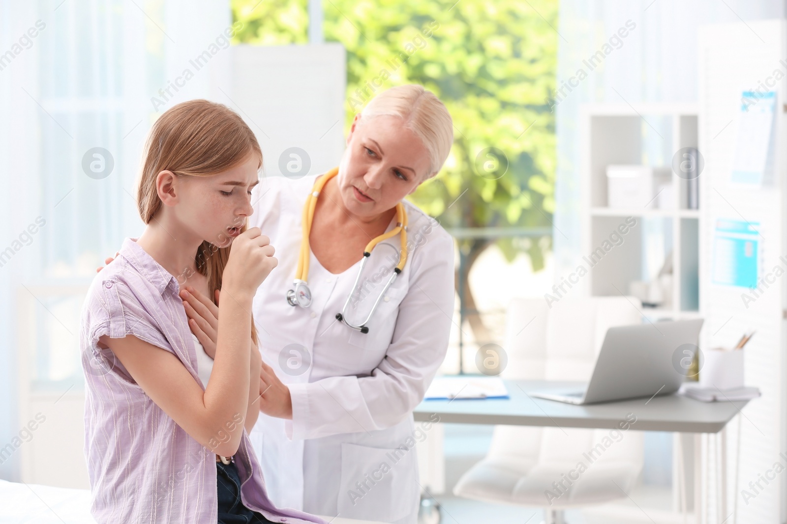 Photo of Coughing teenage girl visiting doctor at clinic