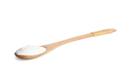 Photo of Wooden spoon with tasty organic yogurt isolated on white