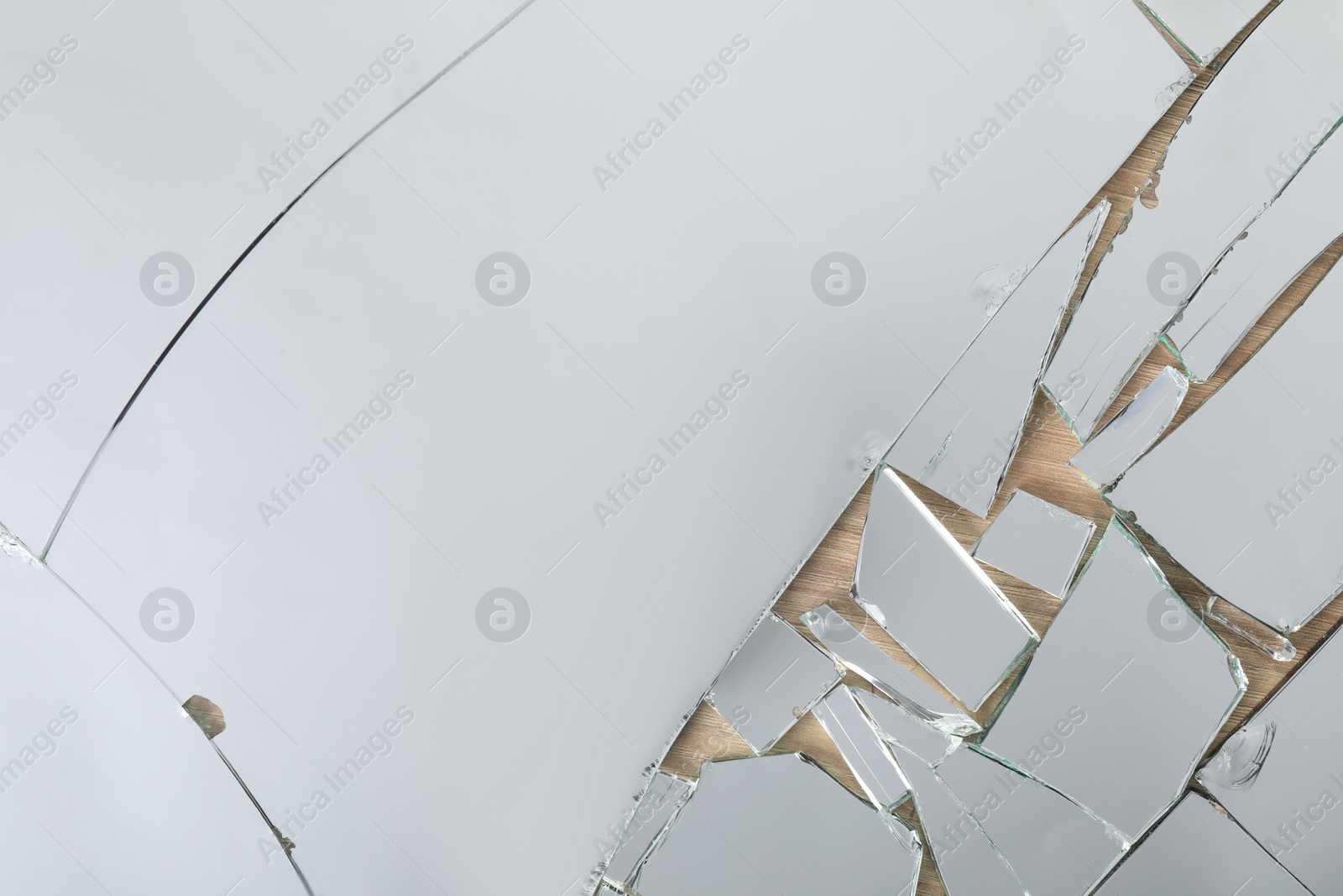 Photo of Shards of broken mirror on wooden background, top view