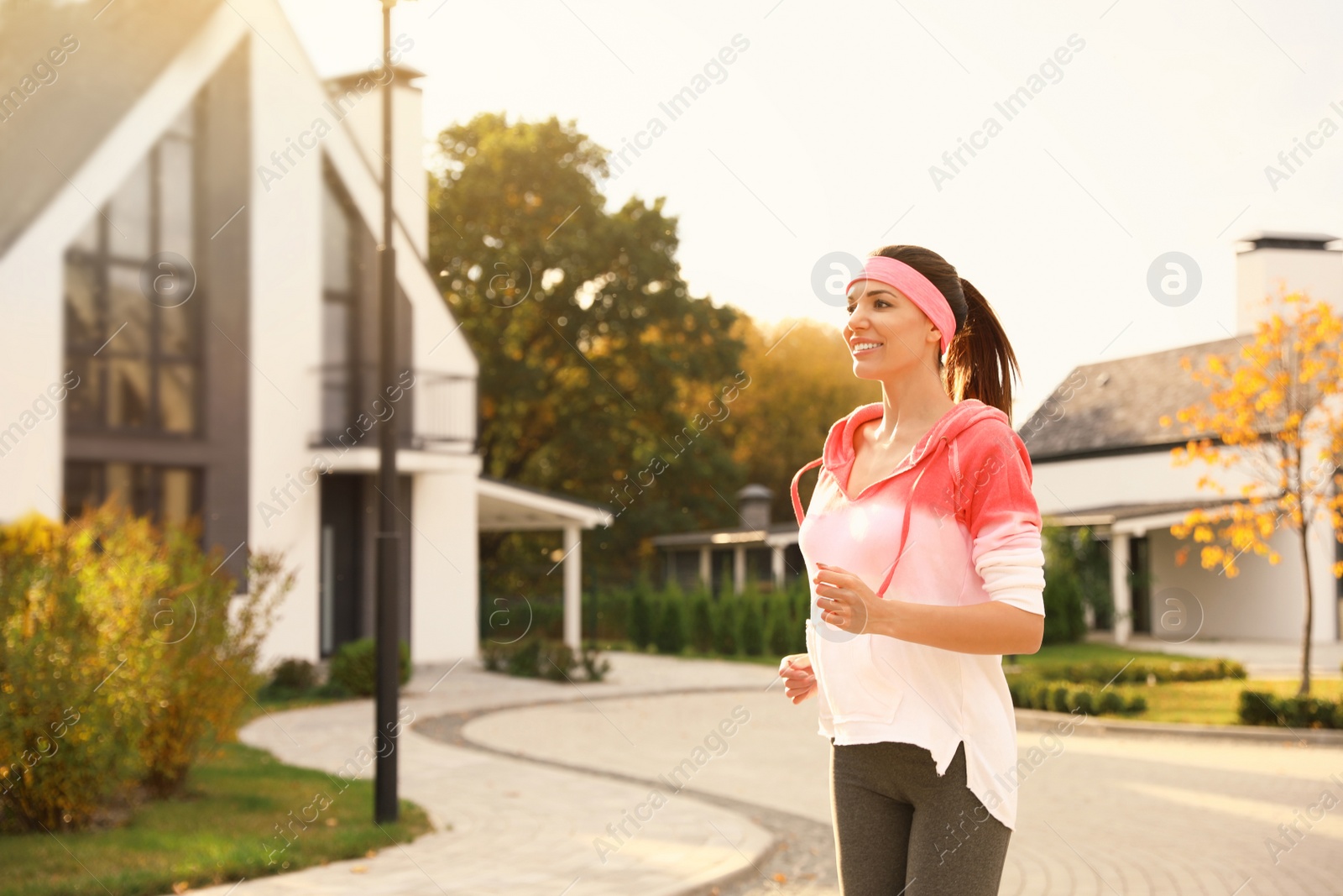 Photo of Beautiful sporty woman running on street. Healthy lifestyle