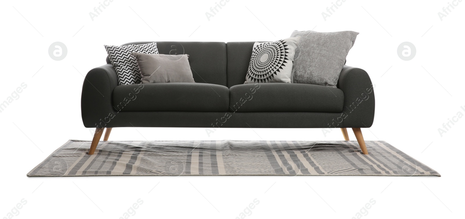 Photo of Comfortable grey sofa with cushions and carpet on white background. Furniture for living room interior