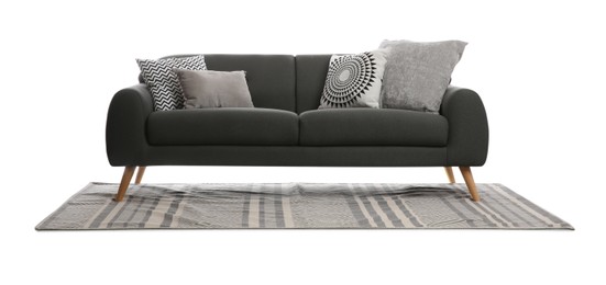 Comfortable grey sofa with cushions and carpet on white background. Furniture for living room interior