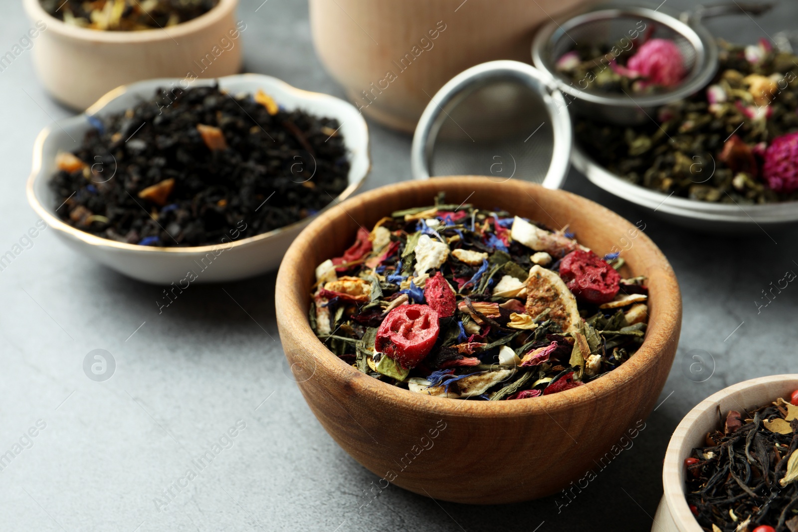 Photo of Many different herbal teas on grey table