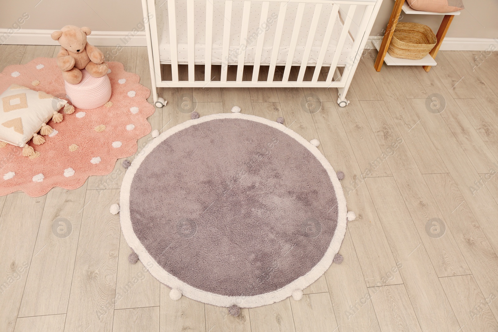 Photo of Baby room interior with modern furniture and soft rug, above view