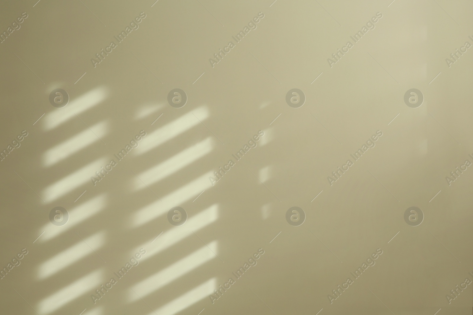 Photo of Light and shadow from window on beige wall indoors