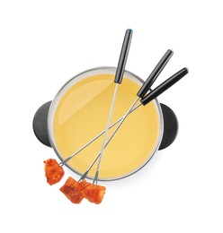 Photo of Oil in fondue pot and forks with fried meat pieces isolated on white, top view