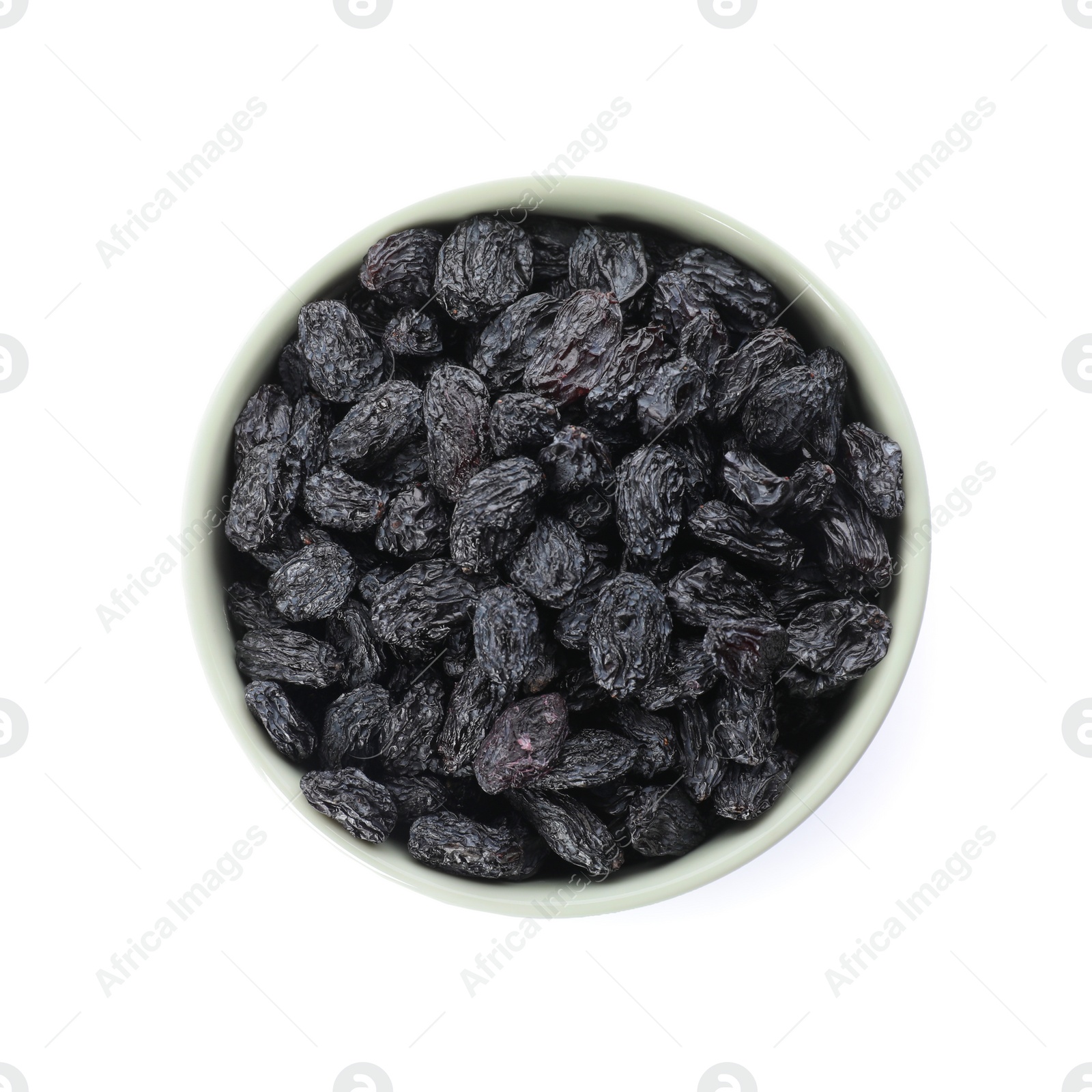 Photo of Bowl with dried dark raisins isolated on white, top view. Healthy nutrition with fruits