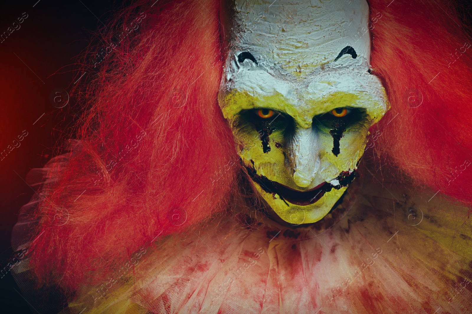 Photo of Portrait of terrifying clown, closeup. Halloween party costume