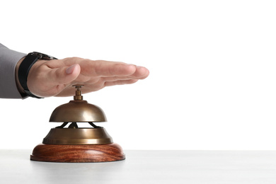 Man ringing hotel service bell at light table