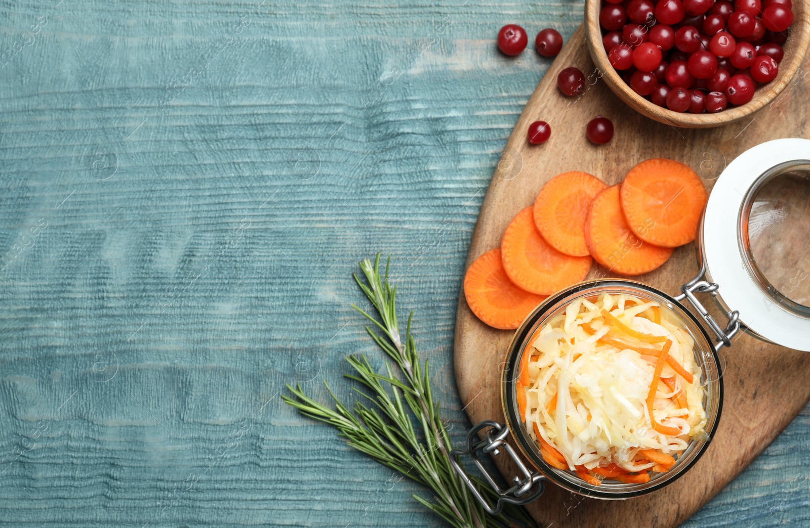 Photo of Flat lay composition with fermented cabbage on blue wooden table, space for text